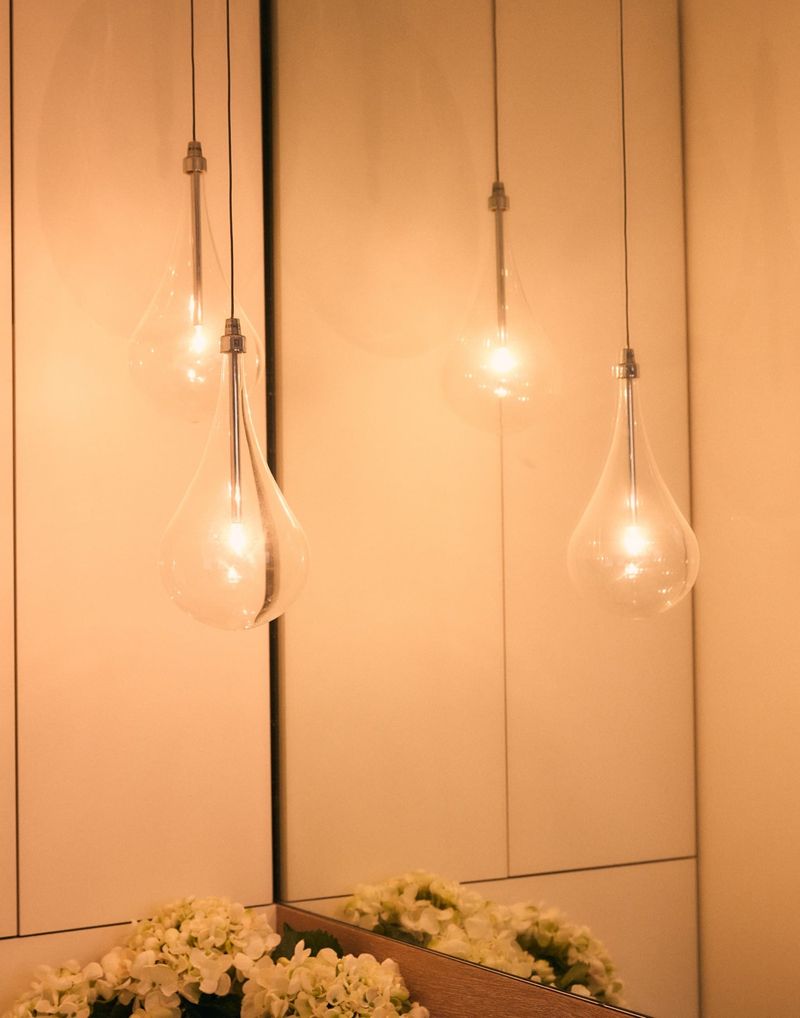 Finished installation of glass teardrop pendant lights in a warm-lit bathroom, Hobart Tasmania