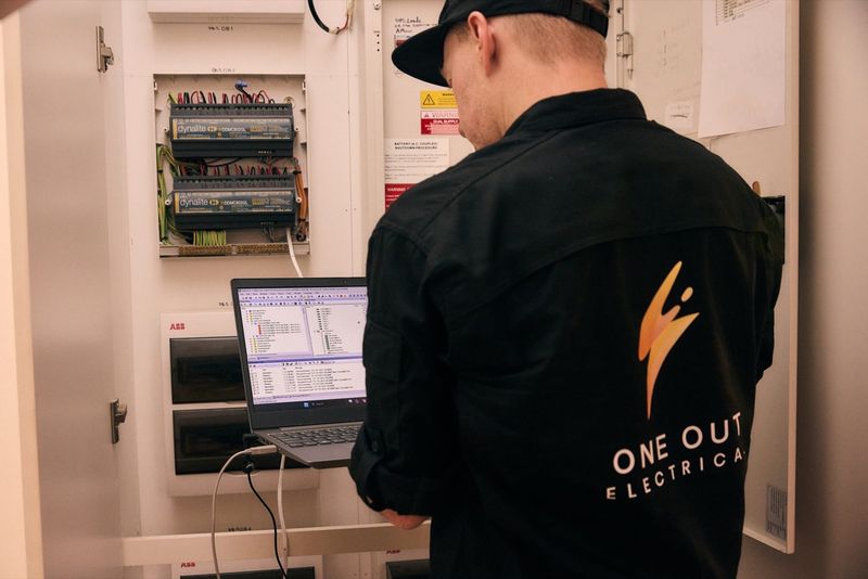 One Out Electrical technician updating a Dynalite smart lighting control system at a residential property