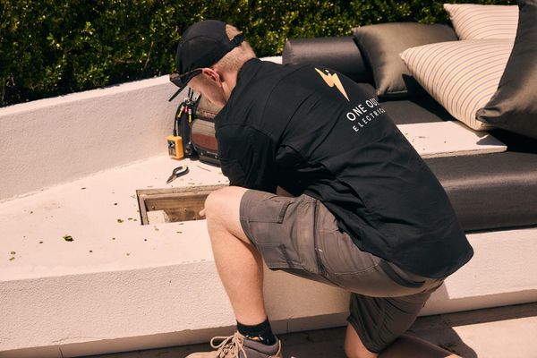 Electrician working on an outdoor power installation at a residential garden in Hobart