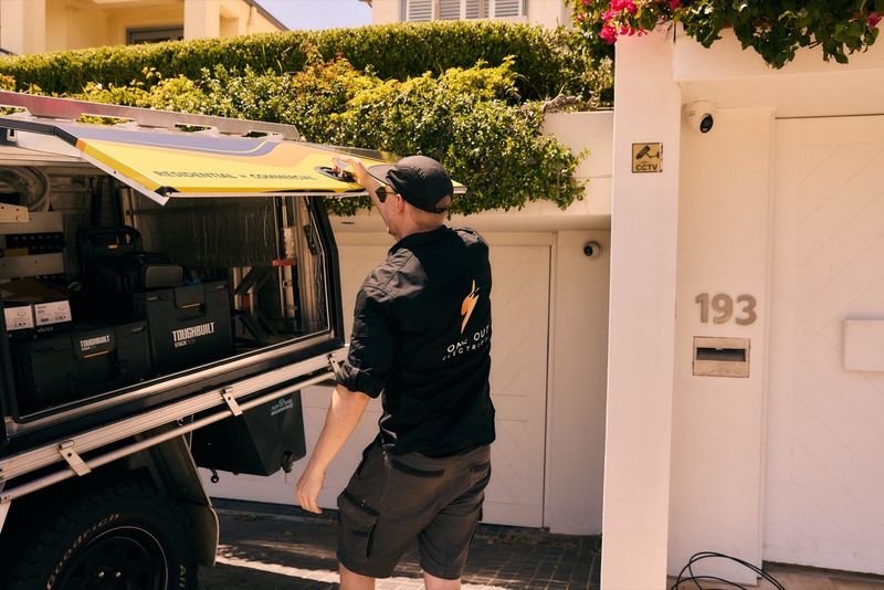 One Out Electrical branded service ute parked outside a residential property in Hobart, Tasmania