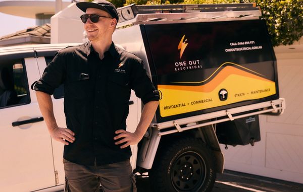 One Out Electrical licensed electrician standing beside the company service vehicle in Hobart, Tasmania
